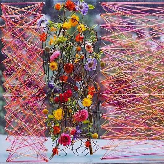 Linear elements and intense pops of color are the main attractions of this floral display.