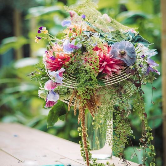 Watercolor-esque hues and cascading botanicals are the showstopping elements of this arrangement, titled "Inspired by the Structure."