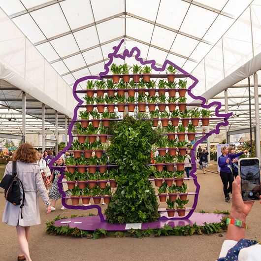 Celebrity florist Simon Lycett creates a bespoke silhouette of Queen Elizabeth II, presented at the 2022 RHS Chelsea Flower Show.