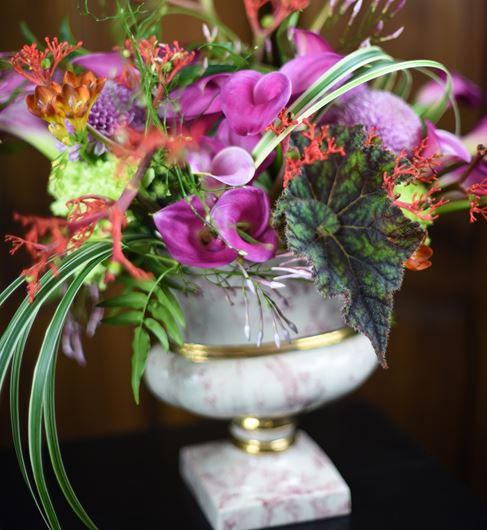 Antique porcelain urn displaying an eclectic mix of botanicals.